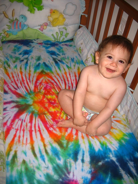 Ma'or (my son) with his groovy tie dyed crib sheets